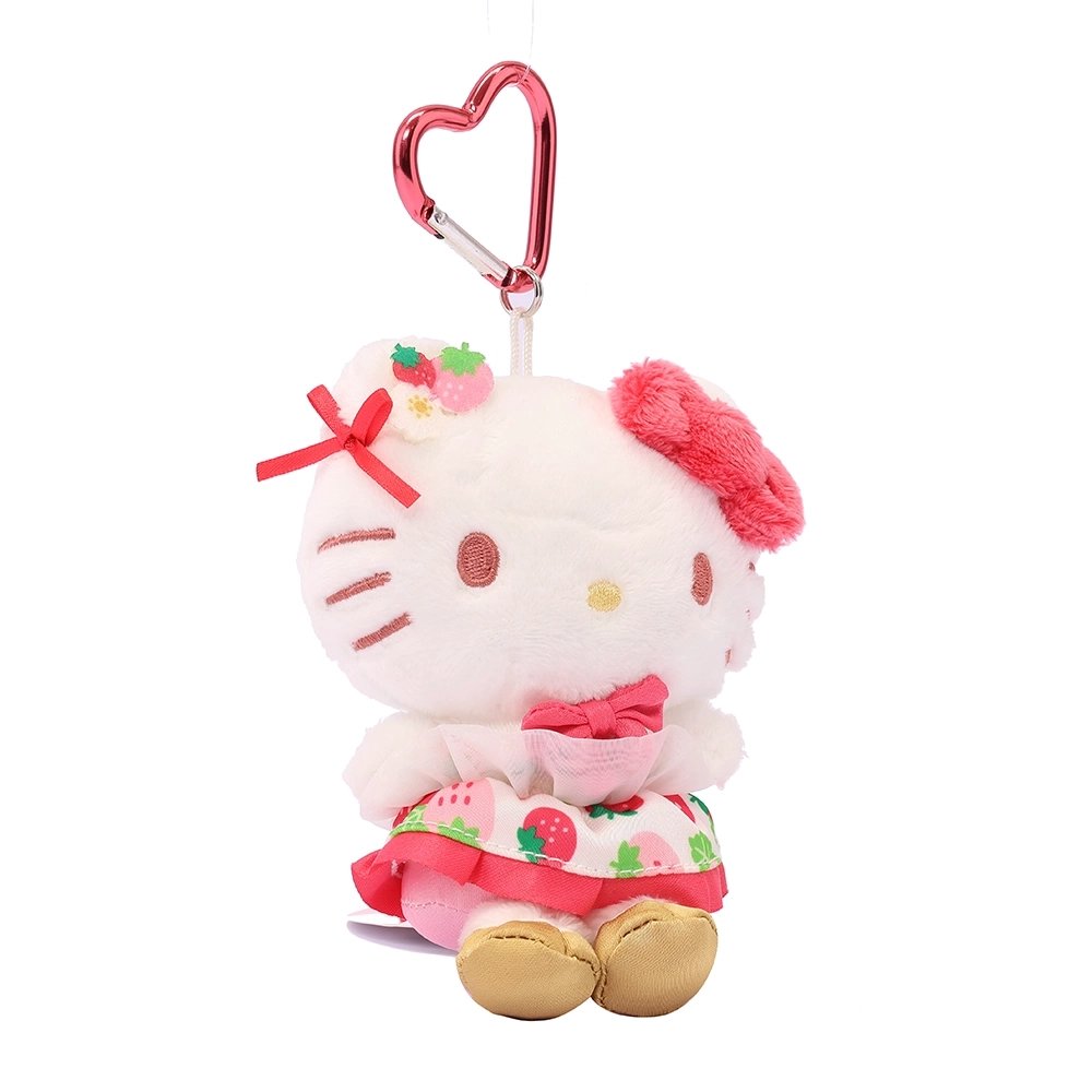 Officially licensed Sanrio Hello Kitty plush keychain from the Strawberry News 50th Anniversary Series. The plush wears a strawberry-patterned dress with pink ruffles and gold shoes, featuring a fuzzy pink bow and a metallic pink heart-shaped carabiner. Perfect displaying, bag decoration or gifting Valentine's day gift to Sanrio fans of all ages.