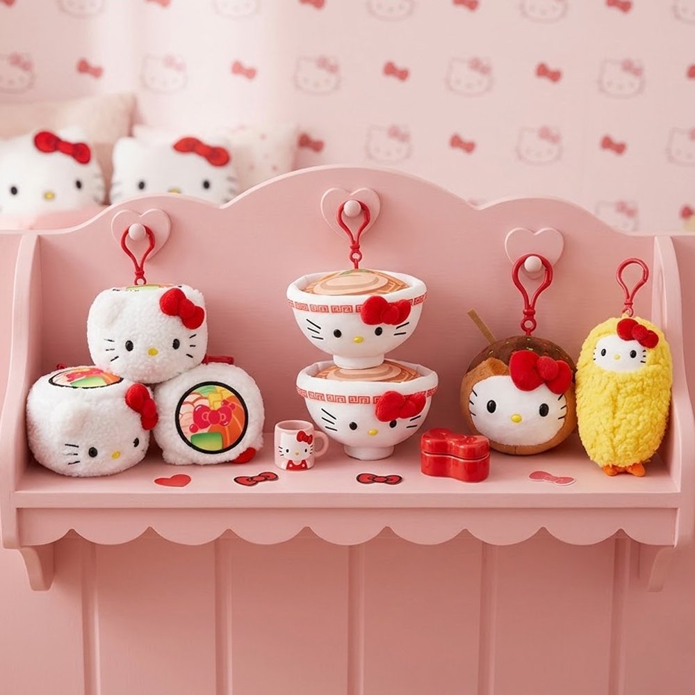 A collection of officially licensed Sanrio plush clips featuring Hello Kitty as various Japanese foods, including a ramen bowl, a sushi roll, a piece of tempura shrimp, and a takoyaki ball, each with a red attachment clip.