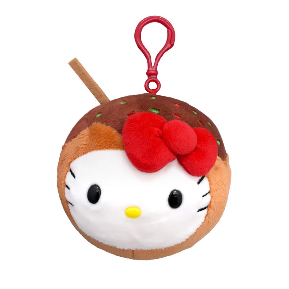 An officially licensed Sanrio plush keychain featuring Hello Kitty as a takoyaki ball with brown sauce, green sprinkles, and a small plush skewer. The round plush includes a red plastic attachment clip at the top.