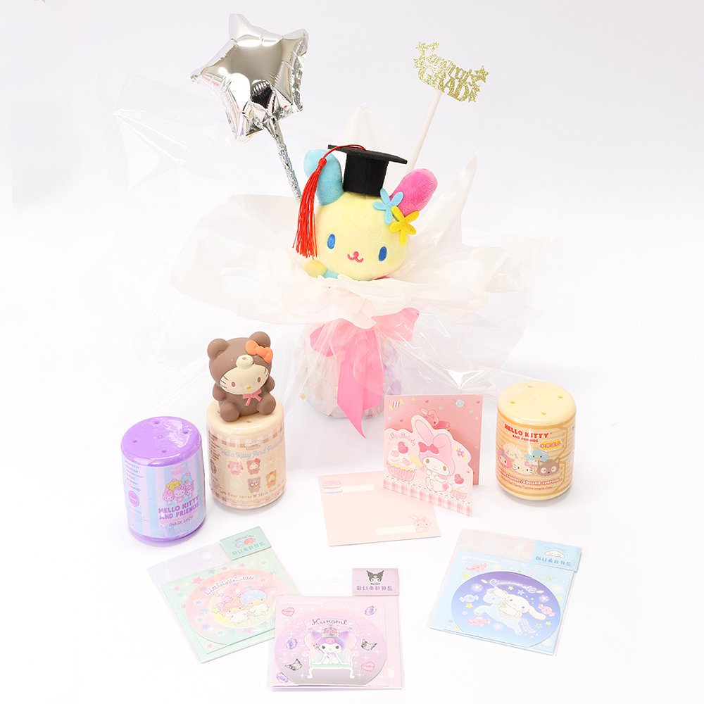 An officially licensed Class of 2026 Sanrio graduation gift set featuring six popular plush characters, Usahana, Corocorokuririn, Wish Me Mell, and Dinguri Days Mashu wearing black graduation caps. The characters are arranged like a bouquet with silver star balloons and "Congrats Grad" decorations.