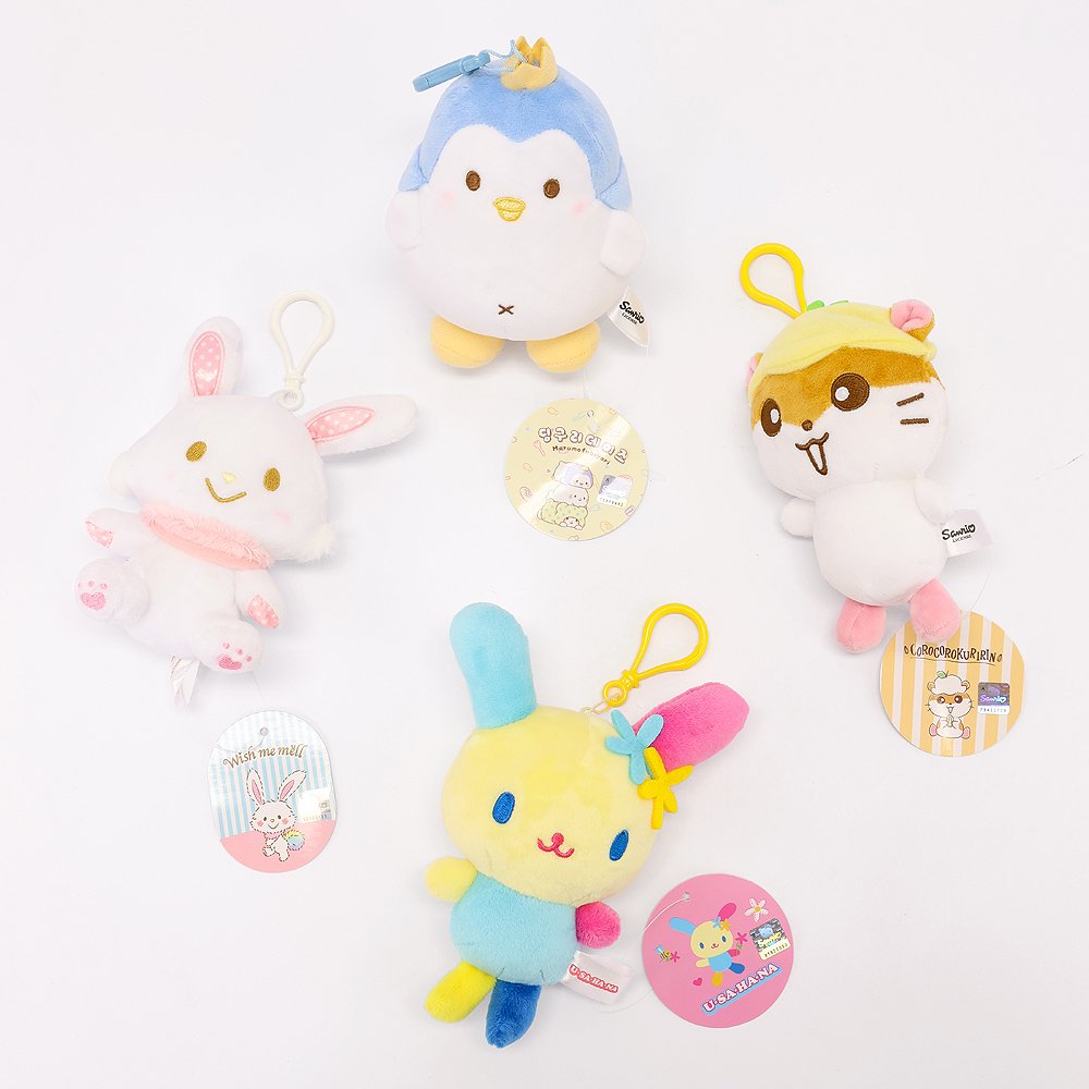 An officially licensed Class of 2026 Sanrio graduation gift set featuring six popular plush characters, Usahana, Corocorokuririn, Wish Me Mell, and Dinguri Days Mashu wearing black graduation caps. The characters are arranged like a bouquet with silver star balloons and "Congrats Grad" decorations.