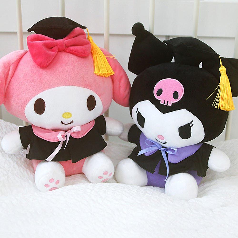 An officially licensed Sanrio Kuromi plush toy dressed in a black graduation cap with a gold tassel and a matching gown featuring a large light purple bow