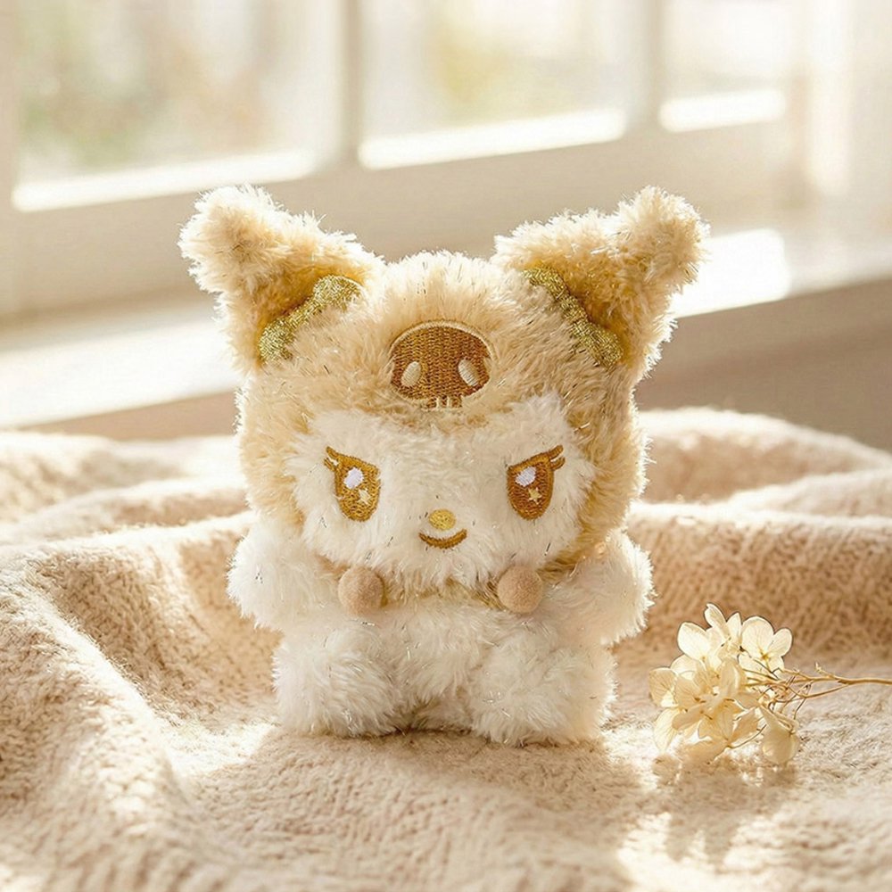 An officially licensed Sanrio Kuromi plush keychain in a shimmering gold and cream colorway, featuring golden embroidered eyes and a skull symbol.