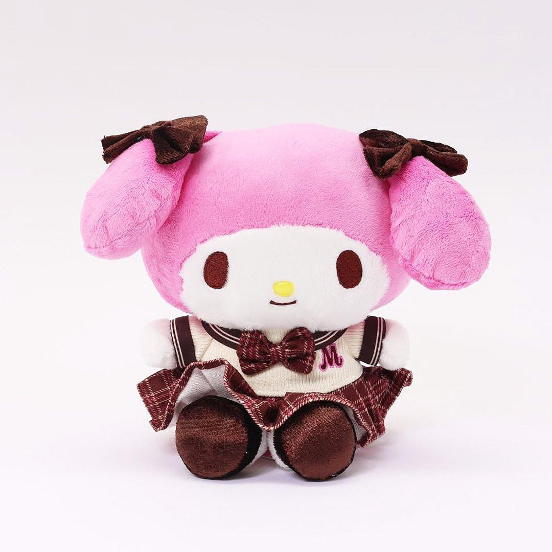 Officially licensed My Melody 8-inch plush doll wearing a beige Knit and plaid school uniform, featuring a large matching plaid bow and brown velvet feet. Ideal collectible toy for fans and Sanrio enthusiasts.