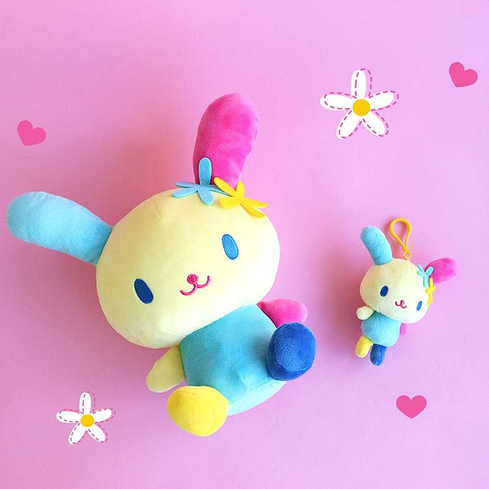 Usahana Plush toy and keychain on a pink background with hearts and flowers.