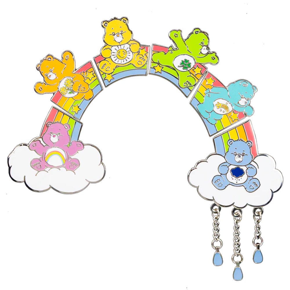 An officially licensed collection of six connecting Care Bears enamel pins forming a colorful rainbow bridge, featuring a Grumpy Bear pin with hanging raindrop charms