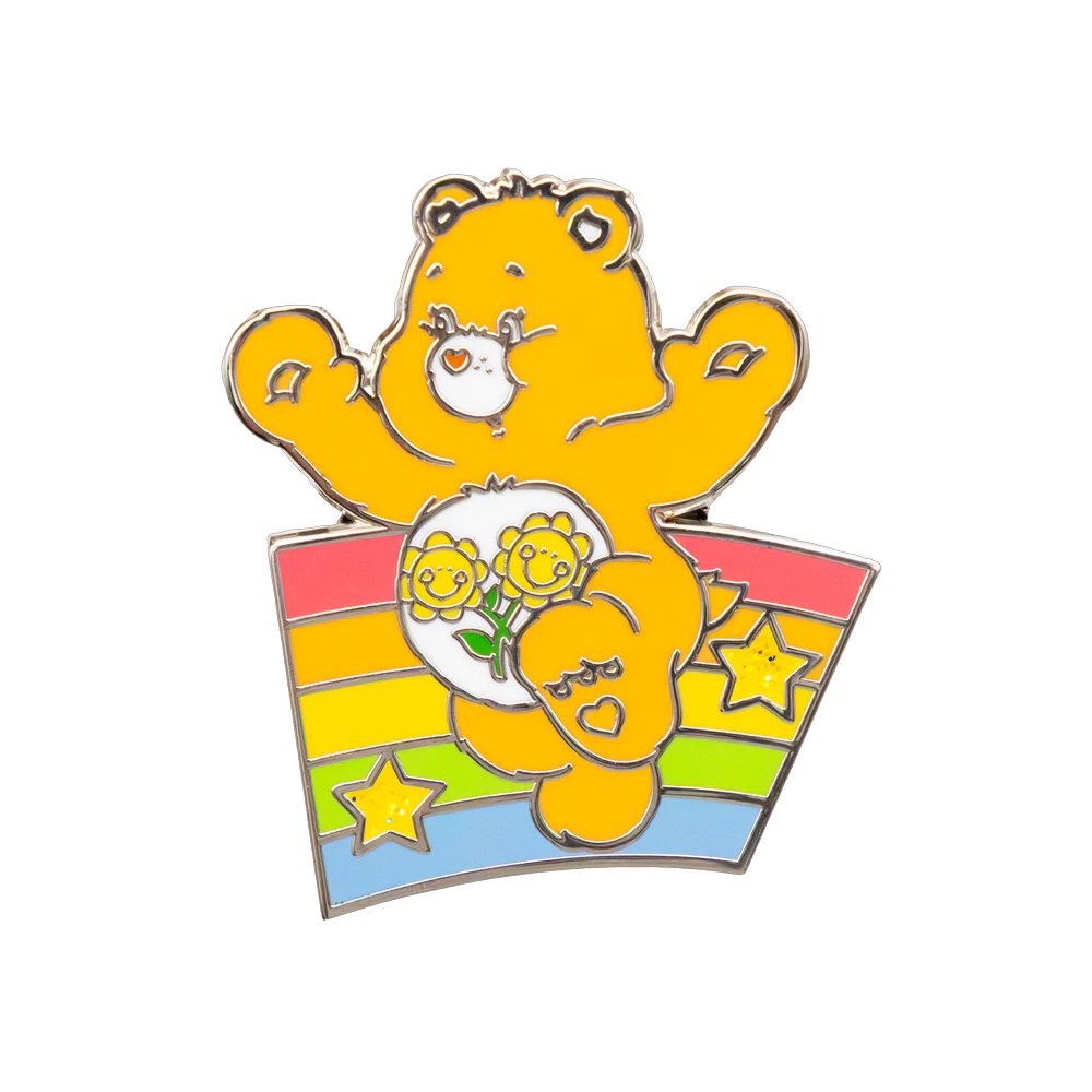 An officially licensed collection of six connecting Care Bears enamel pins forming a colorful rainbow bridge, featuring a Grumpy Bear pin with hanging raindrop charms