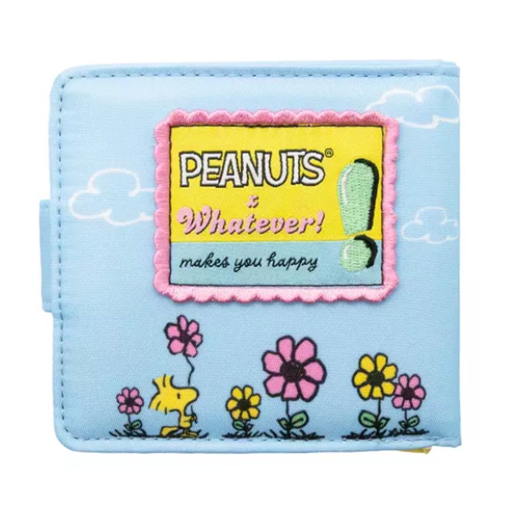 A light blue bi-fold wallet featuring Snoopy and Woodstock relaxing among colorful flowers, shown next to its open view displaying a bright yellow interior with card slots and a clear ID window.