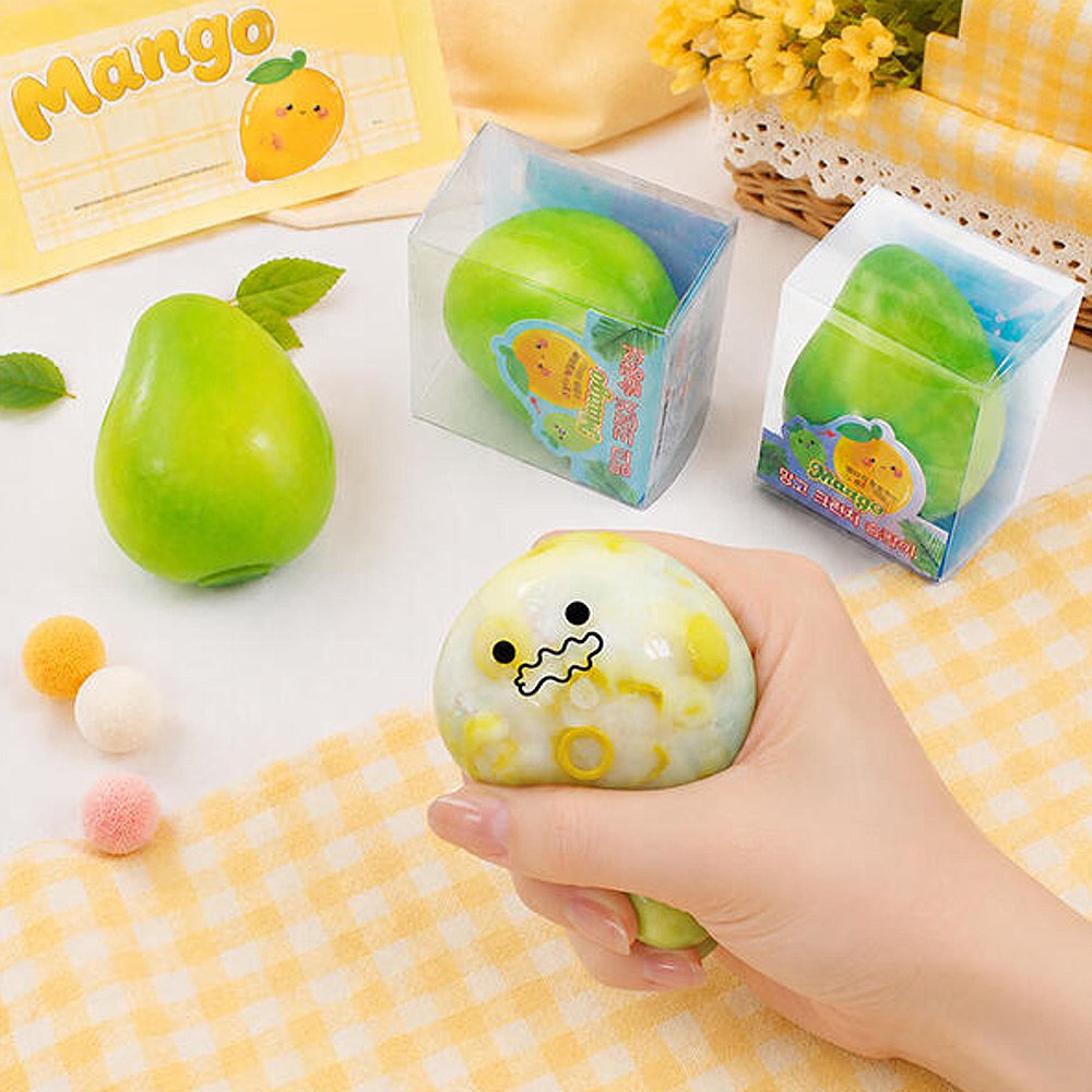 Hands squeezing a green Crunchy Mango Squishy Toy producing crisp ASMR crackle sound, featuring flexible TPR shell, color-changing chameleon effect, perfect Christmas gift and holiday stocking stuffer idea