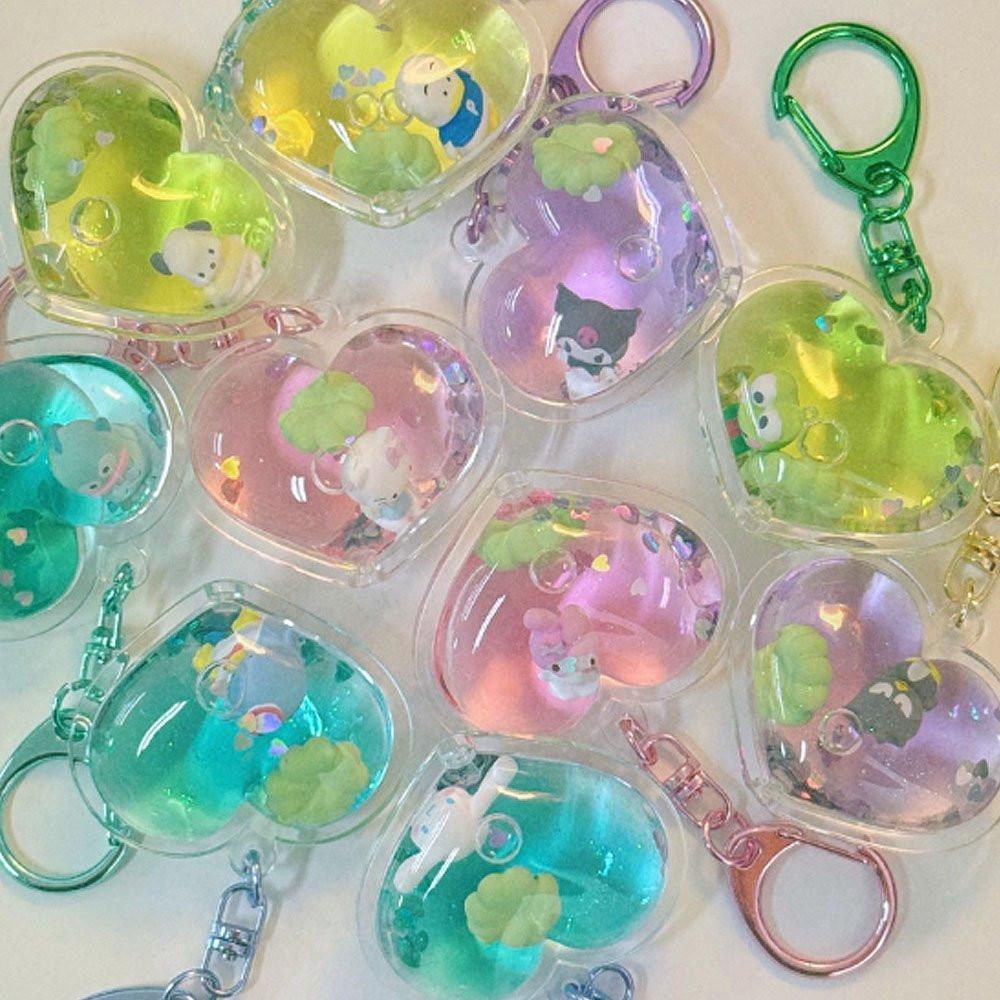 Collection of colorful keychains with Sanrio character designs on a white background