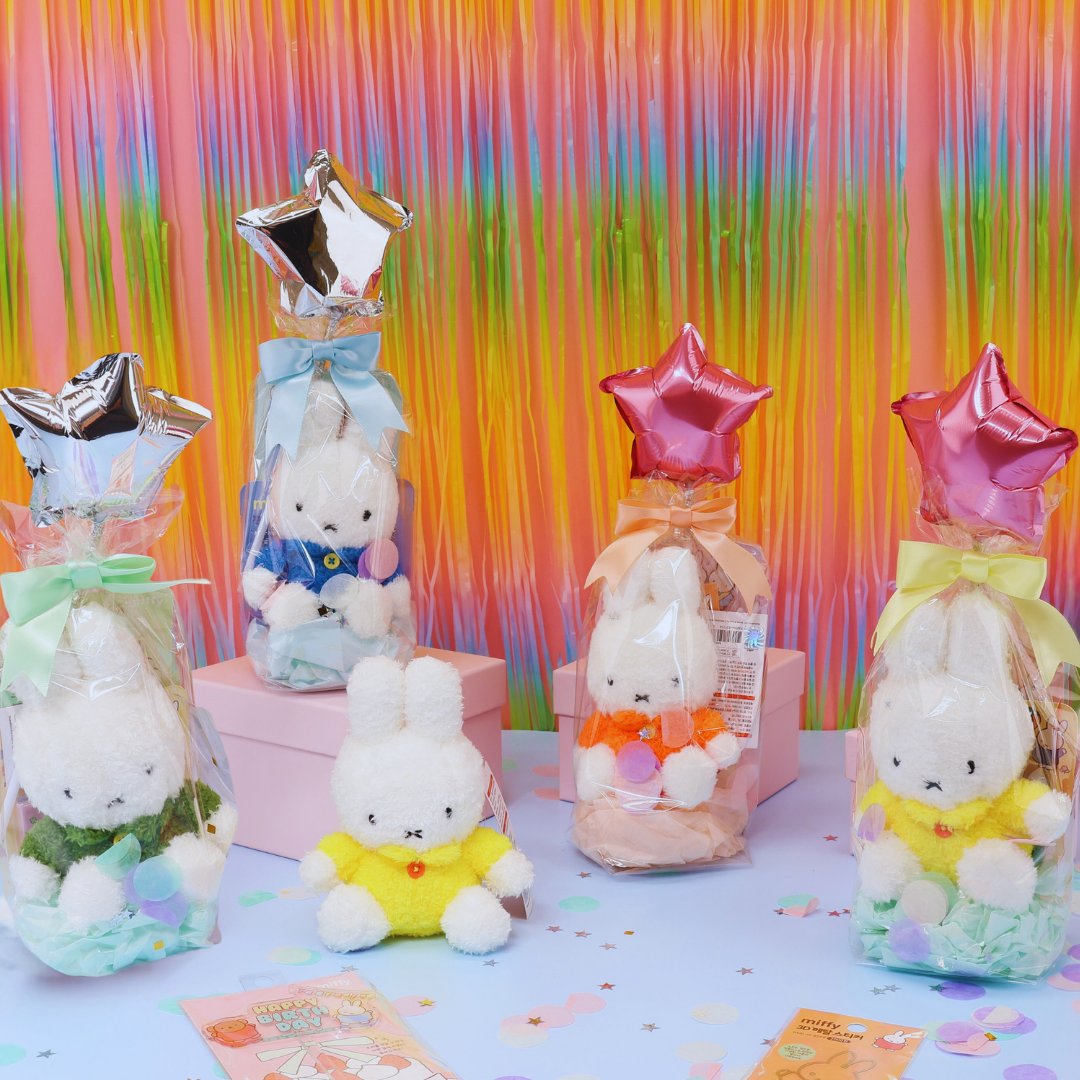 A collection of Miffy-themed birthday gifts including plush keychains, mini notebooks, metal deco stickers, a cake topper, and a letter set, all packaged with a 'Happy Birthday' theme.