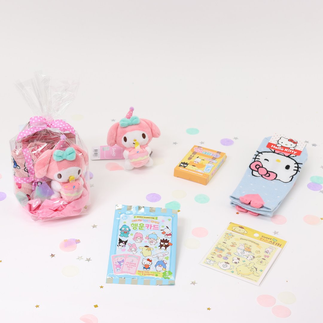 A collection of Sanrio Happy Birthday themed gift sets, each containing various colorful items such as plush keychains and socks, all packaged in clear gift bags with pink ribbons.