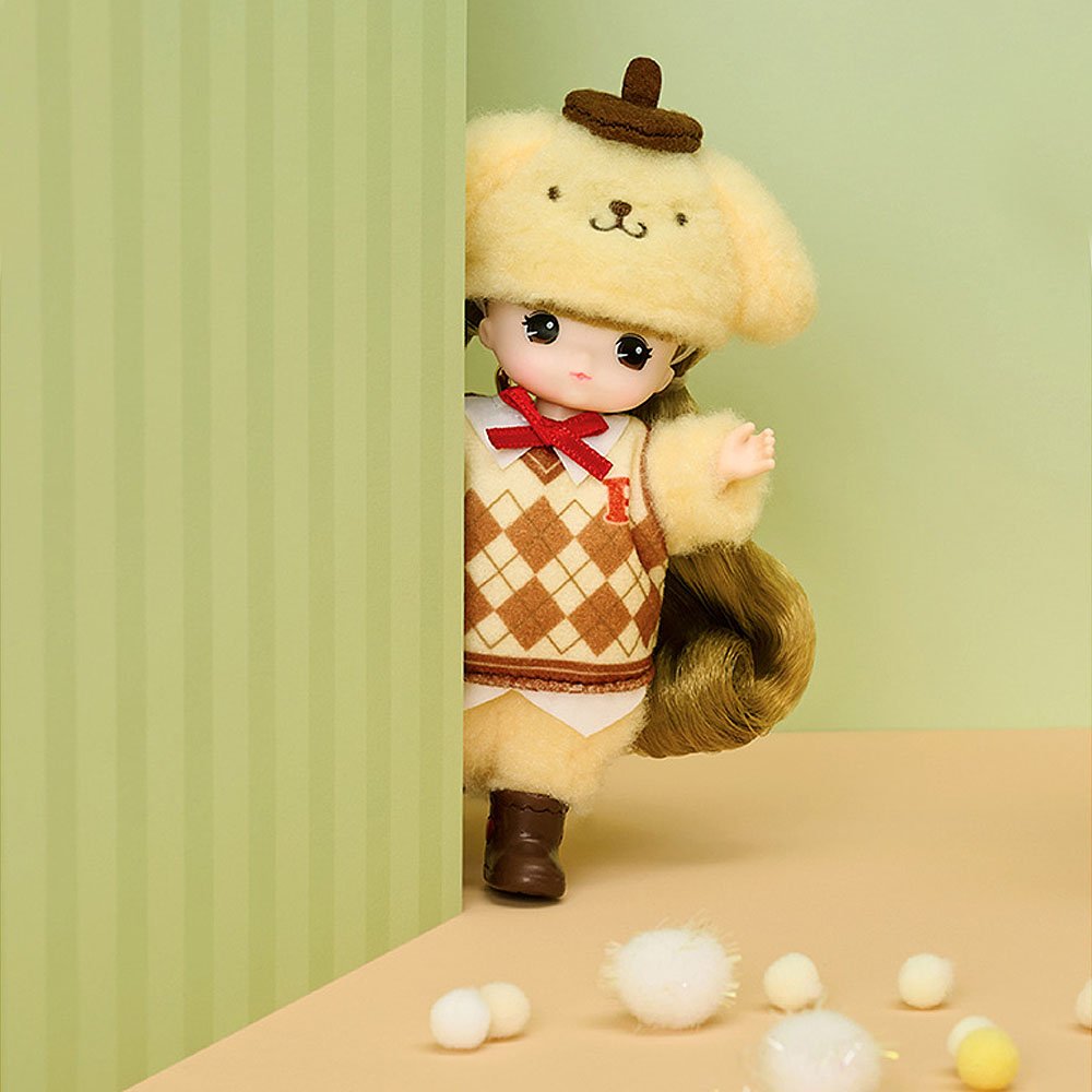 Little Mimi x Sanrio Pompompurin doll with a checkered outfit and hat peeking from behind a green curtain on a beige surface.