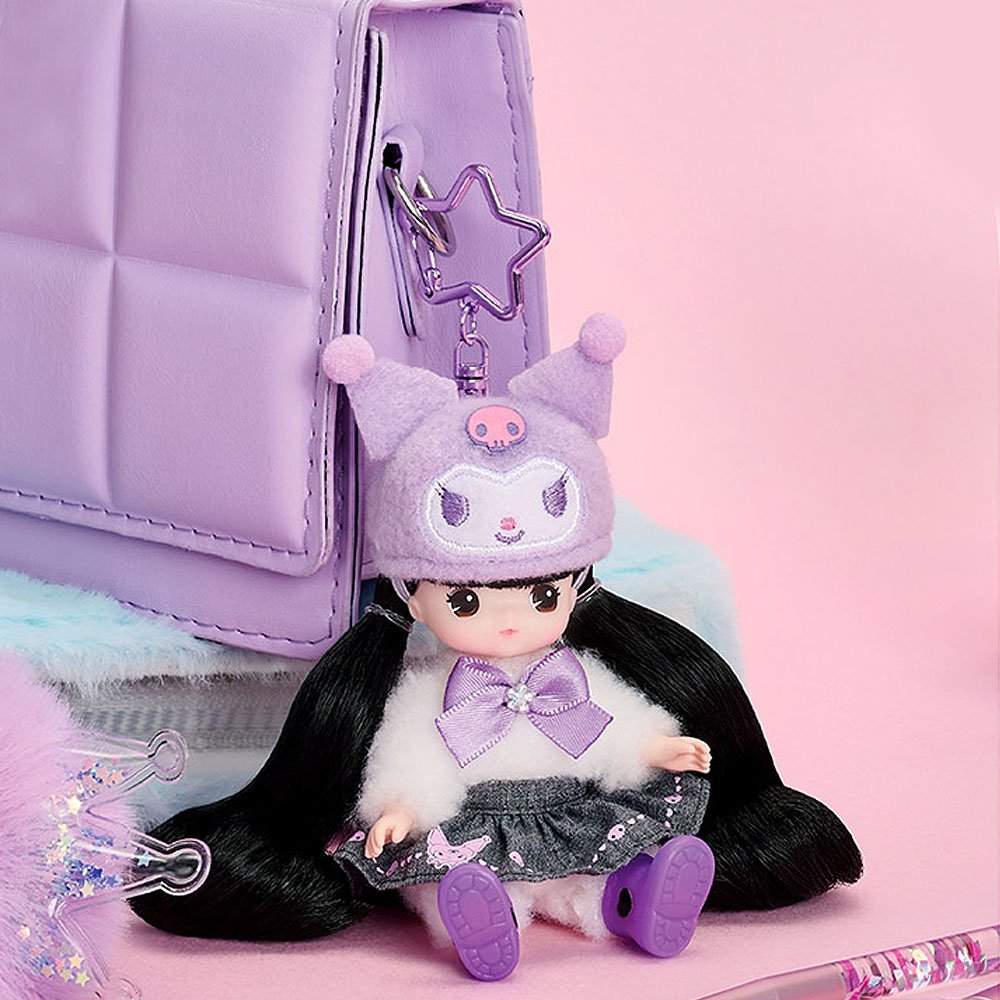 Little Mimi x Kuromi doll with a purple outfit and hat sitting next to a purple backpack on a pink background