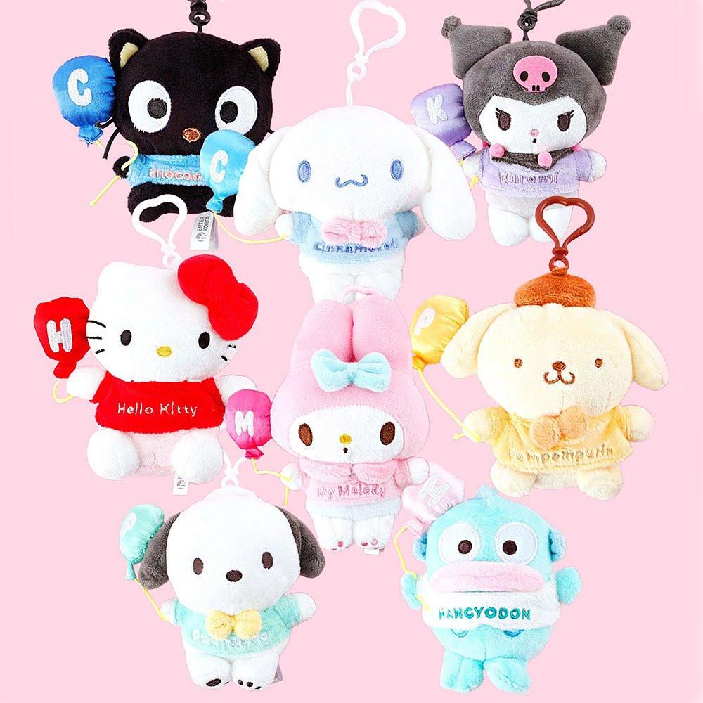Collection of cute Sanrio plush keychains on a pink background
