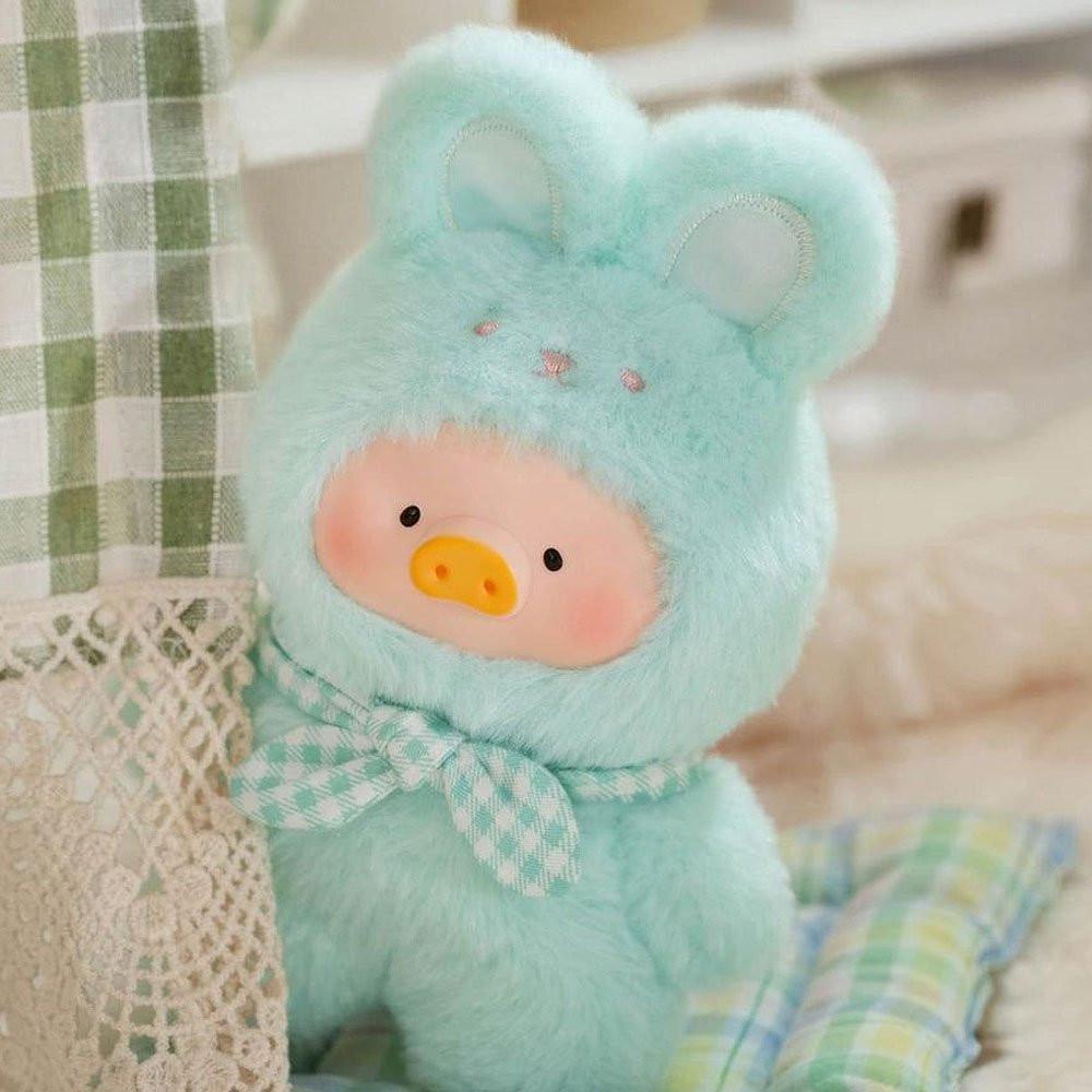 Light blue teddy bear with a checkered bow tie on a soft background