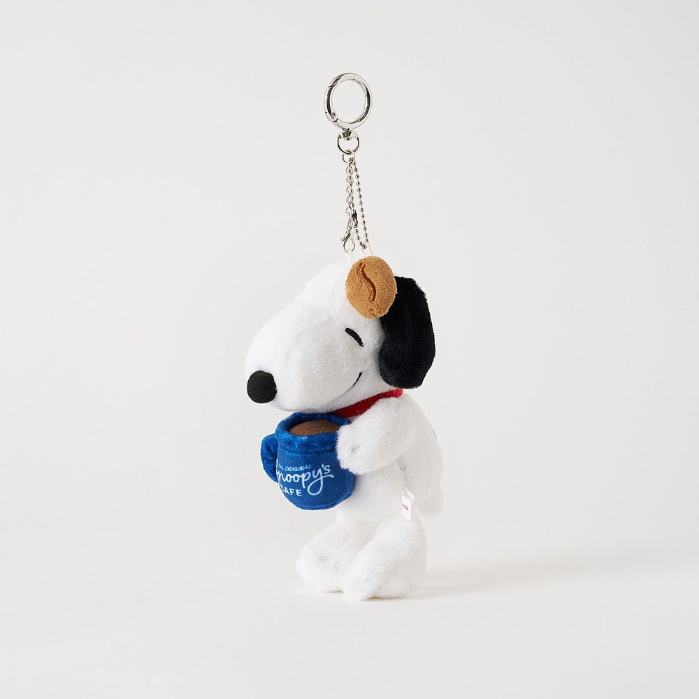 Plush keychain of a Peanut Snoopy wearing a blue scarf with text on a white background