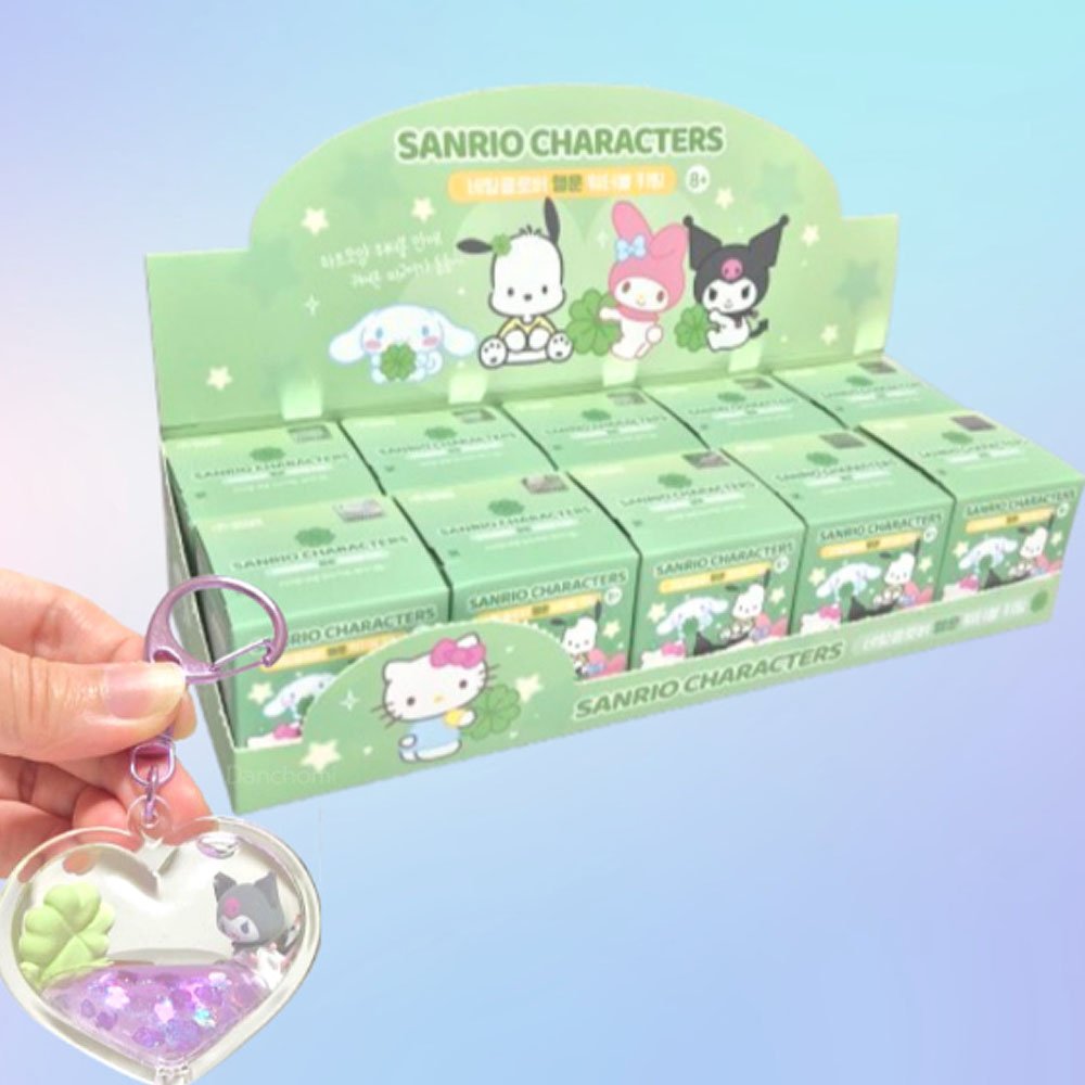 Display of Sanrio character boxes with a hand holding a keychain in front.