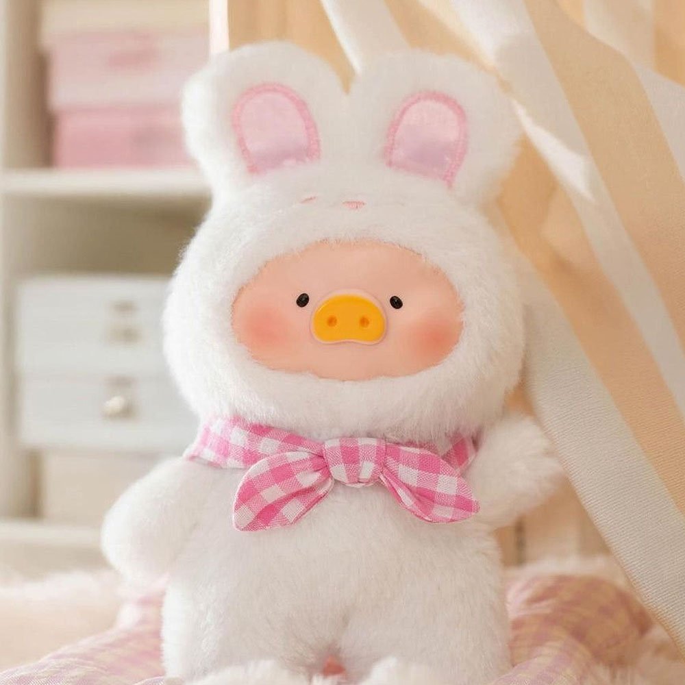 Cute plush toy with bunny ears and a pink bow in a soft, blurred background