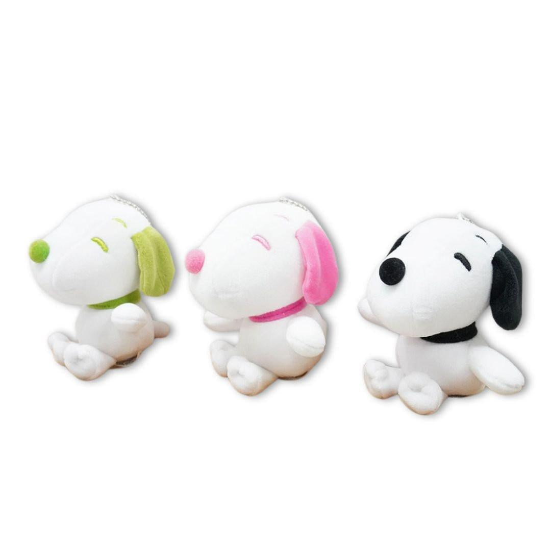 Three color Snoopy plush dolls — pink, green, and black — perfect for collectors
