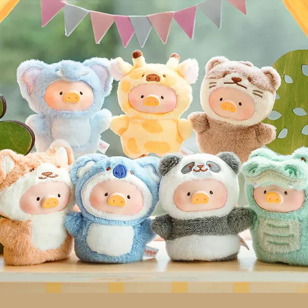 Set of plush toys with animal costumes on a wooden surface with a colorful banner in the background.