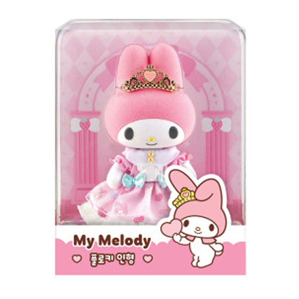 Sanrio My Melody Flocky Doll, a plush toy with intricate lace details, a removable outfit, and a sparkling tiara. The doll is pink with white and blue accents and is posed in a sitting position
