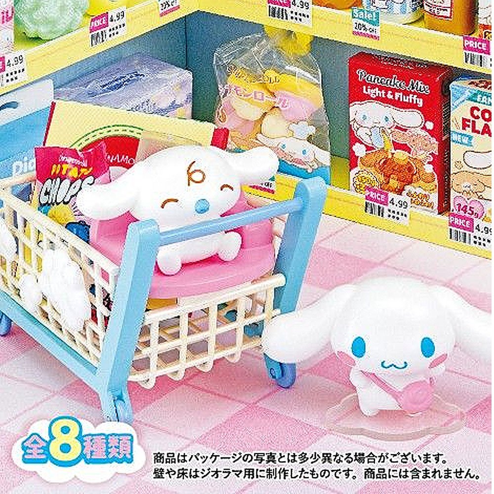 Toy shopping cart with a Cinnamoroll figure toy inside, surrounded by miniature food packages on a pink tiled floor.