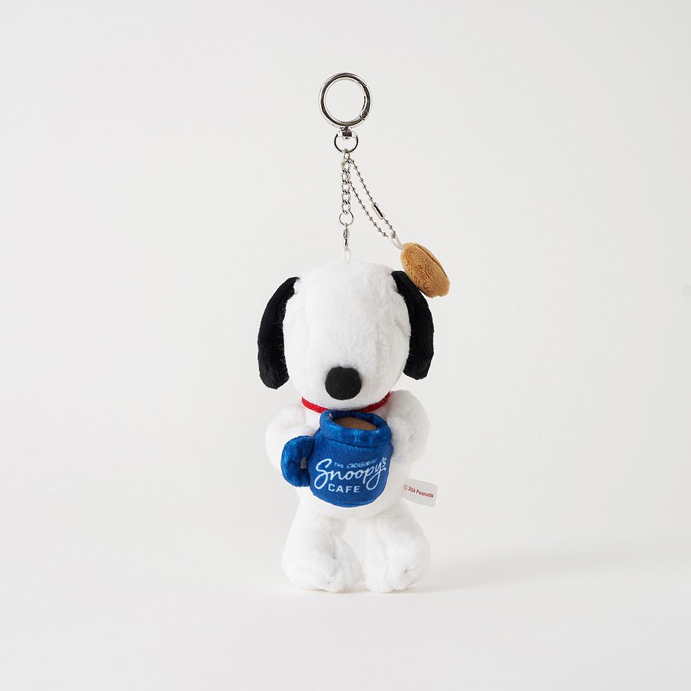 Plush keychain of a Snoopy holding a mug with 'Snoopy Cafe' on a white background