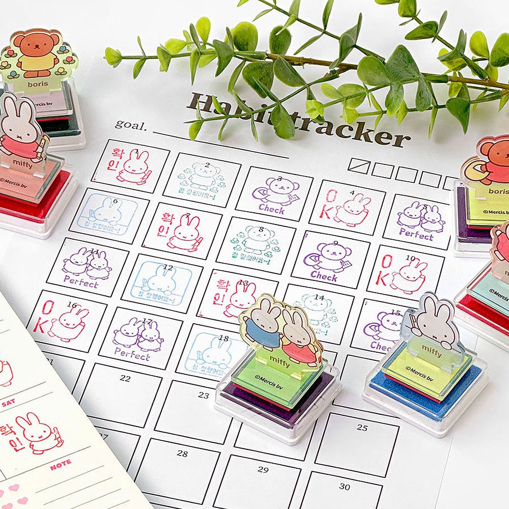 Children's homework tracker with Miffy and Boris character stamps on a white surface with green leaves.