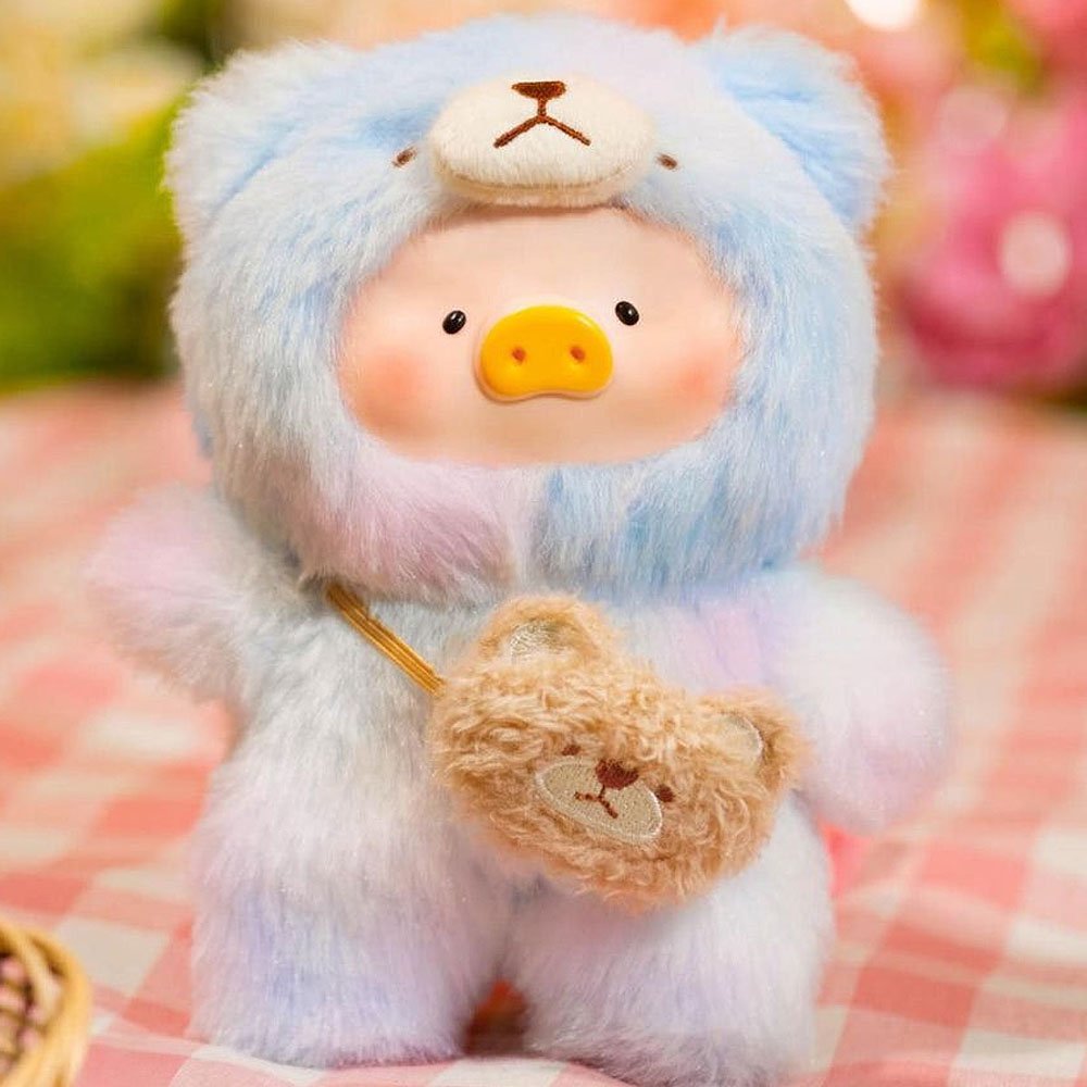 Plush toy bear in a colorful outfit with a heart, on a checkered fabric background.