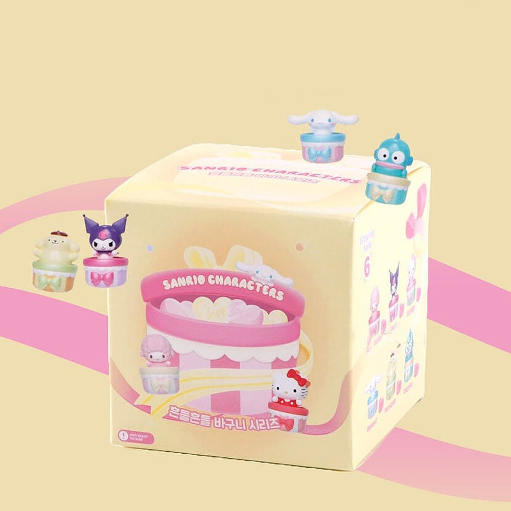 Box of Sanrio character toys on a yellow background