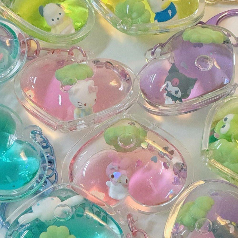 Collection of small figurines in transparent cases on a white background