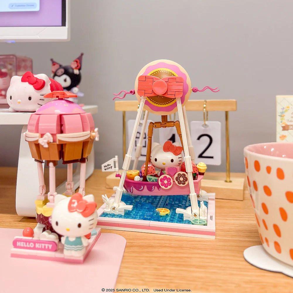 Hello Kitty-themed toy set with a pink and orange polka dot cup on a wooden surface.