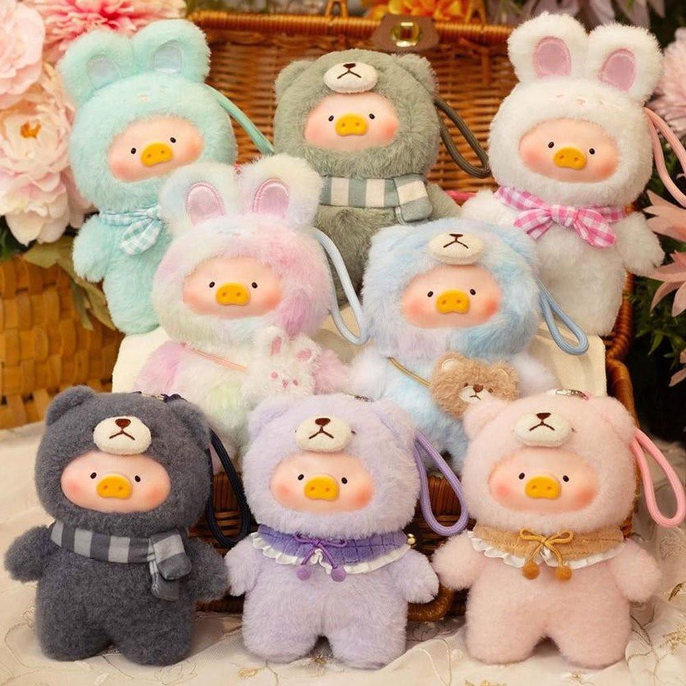 Collection of colorful plush toys with animal ears and faces on a floral background