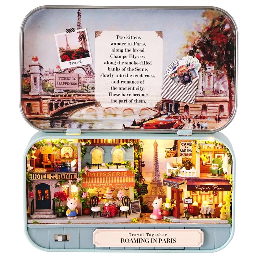 A intricate DIY miniature kit replicating a traditional Parisian cafe with a European designed facade, outdoor seating, and warm LED light