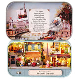 A intricate DIY miniature kit replicating a traditional Parisian cafe with a European designed facade, outdoor seating, and warm LED light