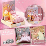 A whimsical DIY miniature bedroom featuring a plush pink bed with bunny pillows, a glowing bedside lamp, and starry wall decor