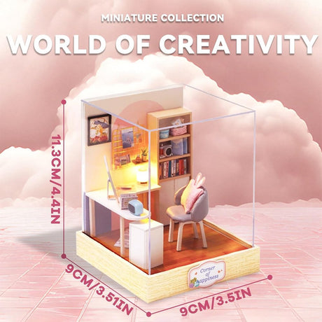 A cozy DIY miniature study room featuring a white desk with a computer, a bookshelf, and a gray chair with a pink bunny-ear cushion