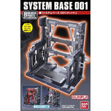 An officially licensed Bandai System Base 001 model kit display stand in metallic gunmetal gray. The retail packaging shows the mechanical hangar holding 1/144 scale Gunpla figures, highlighting its adjustable structural parts and industrial detail.
