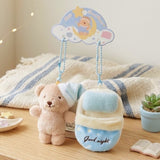 Bella Sweet Dream plush teddy bear wearing a blue nightcap tucked inside a cozy blue plush sleeping bag keychain set