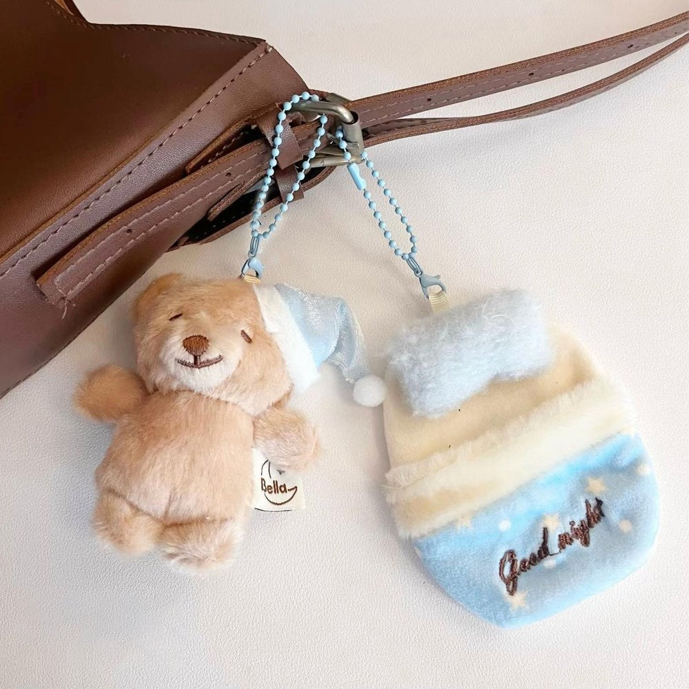 Bella Sweet Dream plush teddy bear wearing a blue nightcap tucked inside a cozy blue plush sleeping bag keychain set