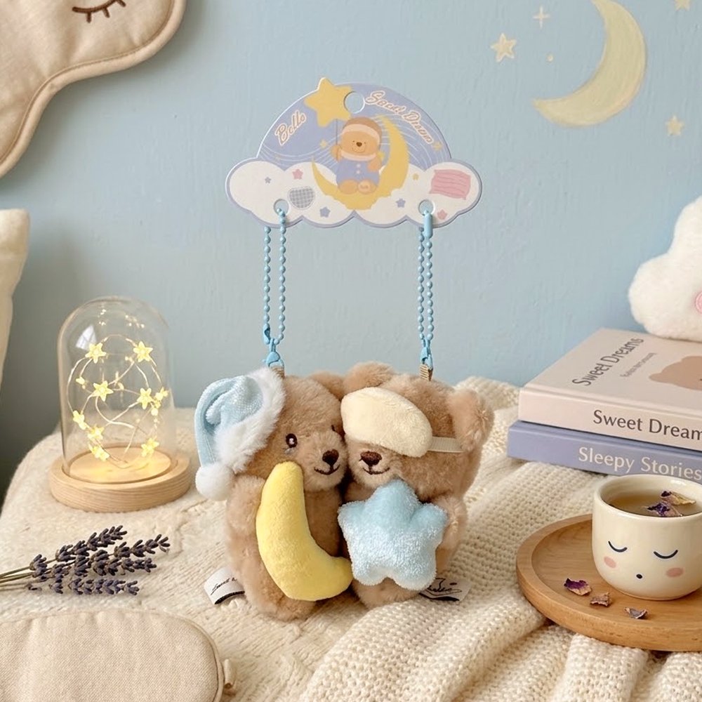 Pair of magnetic Bella Sweet Dream Moon & Star plush teddy bear keychains that stick together, featuring one bear holding a yellow crescent moon in a blue nightcap and another wearing a sleep mask with a blue star