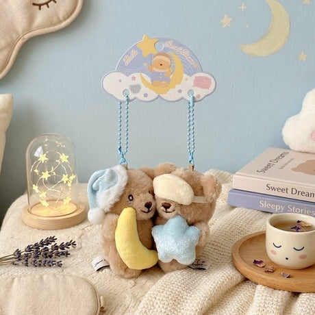 Pair of magnetic Bella Sweet Dream Moon & Star plush teddy bear keychains that stick together, featuring one bear holding a yellow crescent moon in a blue nightcap and another wearing a sleep mask with a blue star