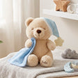 Bella Sweet Dream teddy bear plush toy wearing a blue nightcap with a star and holding a blue blankie with "Bella" embroidered on its foot