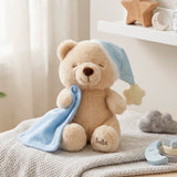 Bella Sweet Dream teddy bear plush toy wearing a blue nightcap with a star and holding a blue blankie with "Bella" embroidered on its foot
