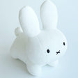 Authentic white Miffy rabbit plush designed with a minimalist Zen aesthetic; this premium soft stuffed animal serves as a nostalgic emotional support object for adults, perfect for modern home decor and workplace mental wellness.