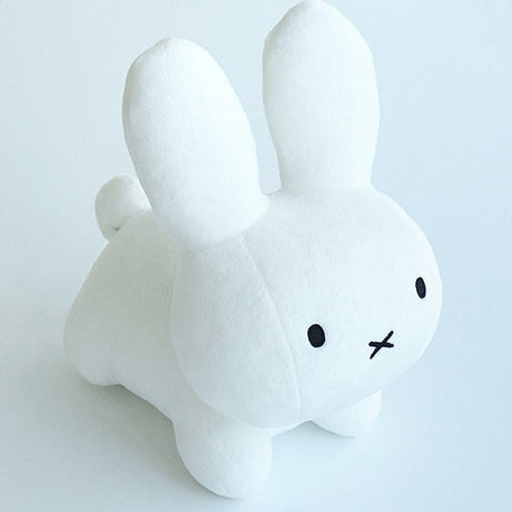 Authentic white Miffy rabbit plush designed with a minimalist Zen aesthetic; this premium soft stuffed animal serves as a nostalgic emotional support object for adults, perfect for modern home decor and workplace mental wellness.