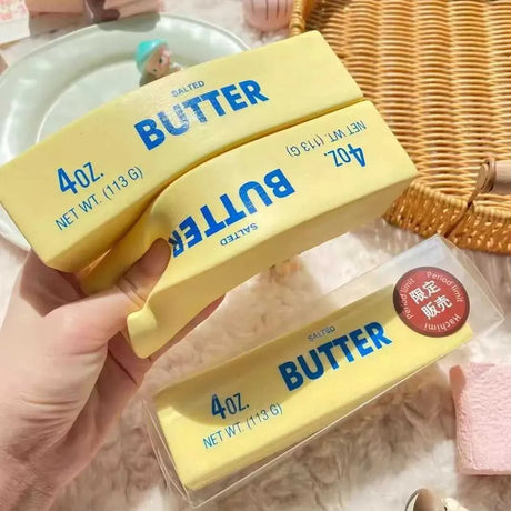 Realistic yellow butter stick squishy stress toy with blue lettering "4oz Salted Butter"