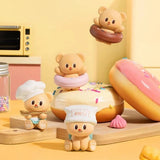 Officially licensed bakery-themed Butterbear collectible mini figures holding baking tools, wearing aprons, and posing with kitchen accessories