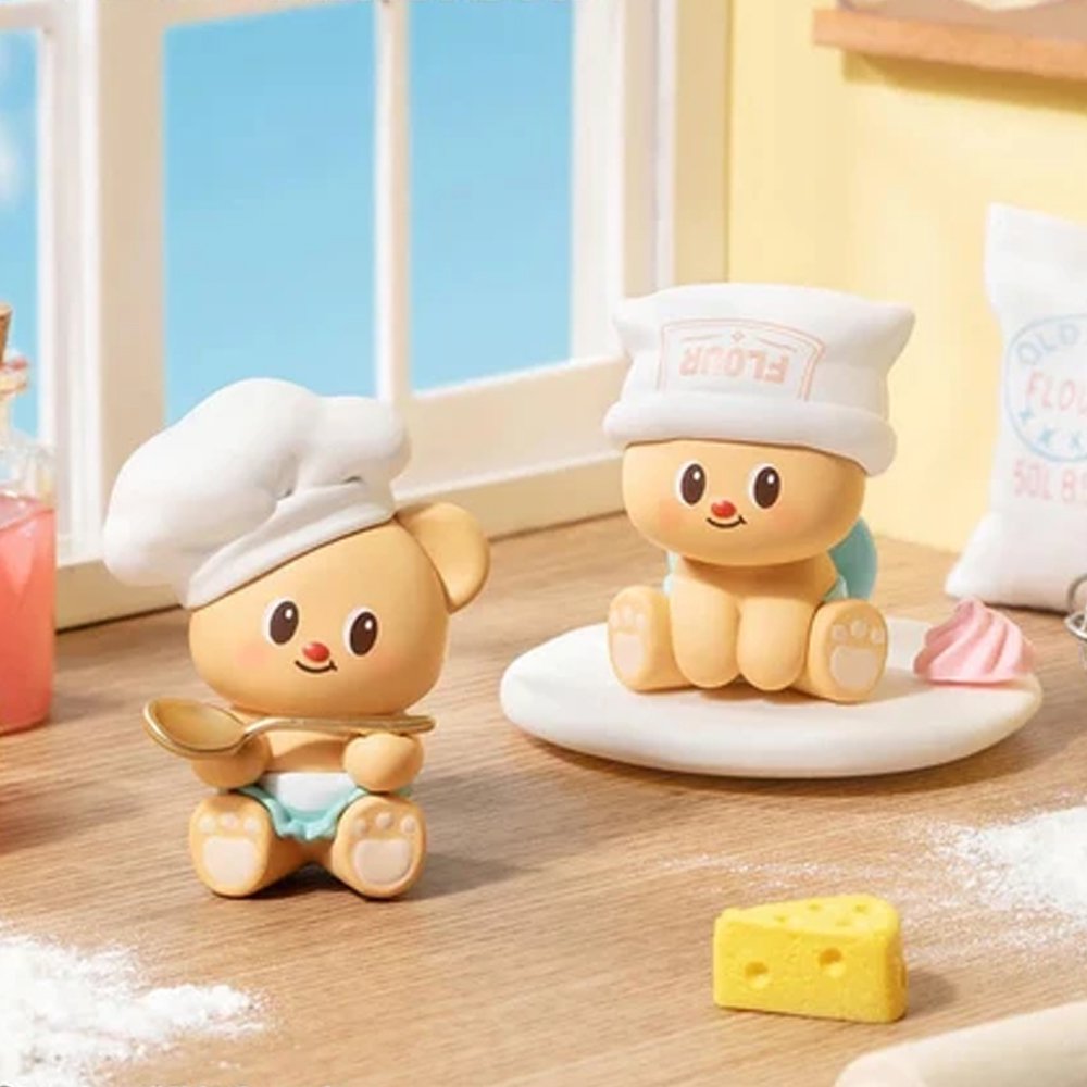 Officially licensed bakery-themed Butterbear collectible mini figures holding baking tools, wearing aprons, and posing with kitchen accessories
